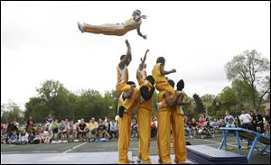 Slug: CTY acrobats03p                               Date 5/02/2010 Toledo Blade/Amy E. Voigt                Location: Toledo, Ohio  CAPTION:  Lindsay Scheinbach(cq), from Sylvania Township, back, and Isabelle VanDyke, 6, from Toledo, front, watch The Chicago Boyz Acrobatic Team perform in honor of the holiday Lag B'Omer at the Jewish Community Center on Sunday on May 2, 2010. The event was sponsored by the Chabad House of Toledo and The Friendship Circle.