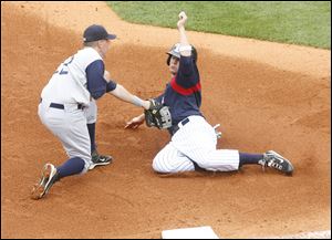 Charlotte third baseman C.J. Retherford tags out Jeff Larish in the fourth inning during Sunday's game at Fifth Third Field.