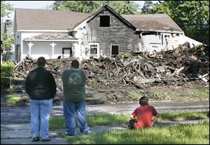 Rubble is all that is left of the apartment building next to Debora Burch's home on Orchard Street.  She said she had worried that the vacant building next door would tempt arsonists.