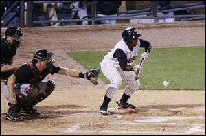 The Mud Hens' Robinzon Diaz lays down a bunt for a base hit in the sixth inning of Toledo's loss Friday night at Fifth Third Field.