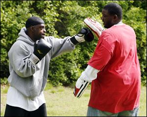 Slug: CTY rover17p The Blade/Jeremy Wadsworth  Date: 05/16/09  Caption: Vernon Louis, left, and Kristopher Henderson (cq) both of Toledo take advantage of the nice weather by getting some exercise Sunday, 05/16/10, at Wildwood Metro Park in Toledo, Ohio.