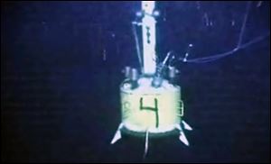 A capping device hangs in the water at the site of the Deepwater Horizon oil spill on Thursday, in this image made from video made available by British Petroleum (BP PLC). 