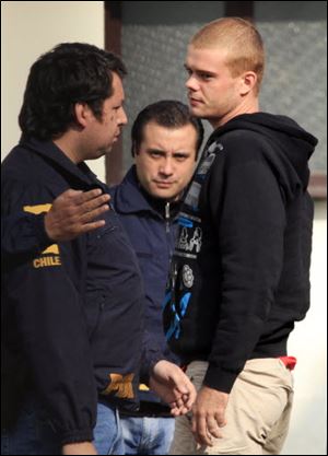 Chile's investigative police officers escort Dutch Joran van der Sloot, right, after being found at a neighborhood in Santiago on Thursday.