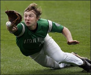 Ottawa Hills outfielder Kyle Jarecki (13) can't hold on to the ball against Fort Loramie during the second inning.