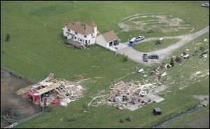 Along County Road 7, houses untouched by the storm sit alongside houses that were shattered during the tornadoes.