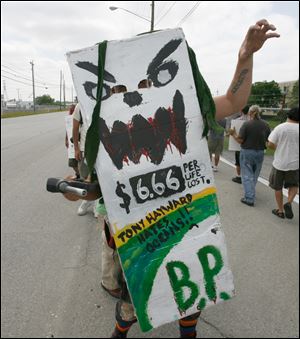 A placard carried by a demonstrator vilifies Tony Hayward, BP's chief executive officer, fo rhis role in guiding the global oil giant's corporate image after the Gulf spill.