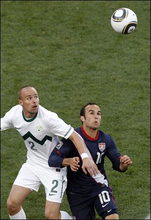 Slovenia's Miso Brecko, left, and United States' Landon Donovan keep their eyes on the ball during the World Cup group C soccer match between Slovenia and the United States at Ellis Park Stadium in Johannesburg, South Africa.