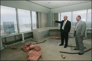 Nick Eyde, left, of the Eyde Co. of Lansing, which owns the building now known as the Tower on the Maumee, tours an upper floor with Mark Briggs, a representative of the Lansing office of Parsons Brinckerhoff, a project-management company.