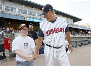 Hens manager Larry Parrish walks Ian Springer to home plate to give the umpire the lineup.