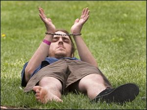 A protester shows his handcuffs after being arrested in Toronto.