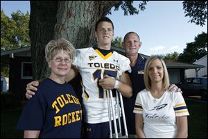 Michael Mathews, who injured his knee in a recent practice, father, Gary, and sister, Emily, are around to offer Michael's mother, Beverly, support in her battle against colon cancer.