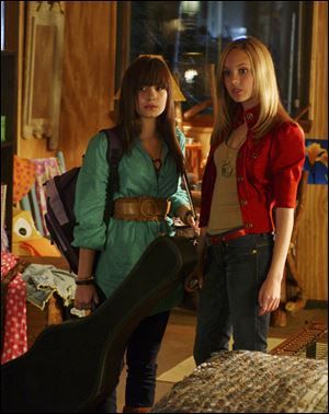 Demi Lovato, left, and Meaghan Jette Martin in a scene from the TV movie ‘Camp Rock.' The sequel airs Friday at 8 p.m.