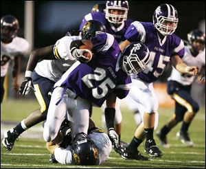 Fremont Ross' Tylor Trautwein, center, is brought down by Whitmer's Nick Wert during Friday night's game won by the Little Giants.<br>
<img src=http://www.toledoblade.com/graphics/icons/photo.gif> <font color=red><b>VIEW GALLERY:</b></font> <a href=