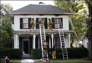 Crews fight a blaze in the home of Perrysburg Municipal Court Judge S. Dwight Osterud and his wife. Their cat died in the fire. 