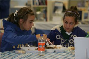 Taylor Pellam, left, and Livie Sears, both of Findlay, share a meal at the festival,