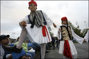 NBR greek10p  Ted Voudaris (cq), left, holds a chair for Mario Kamilaris (cq), 10, a member of the Olympians, a group of young dancers that are part of the Hellenic Dance Company, as he dances onto it. To the right is Theo Pechlivanos (cq). All are from Toledo.  The 40th-annual Greek-American festival sponsored by the Holy Trinity Greek Orthodox Cathedral in Toledo, Ohio on September 11, 2010. The festival continues on Sunday. Jetta Fraser/The Blade