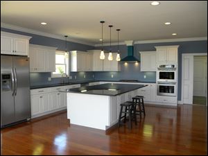 A large work island doubles as a snack bar in this spacious kitchen.