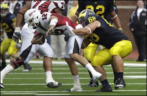 Michigan defensive tackle Mike Martin sacks Massachusetts quarterback Kyle Havens in the second quarter of Saturday's game at Michigan Stadium.