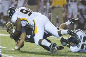 Toledo's Johnie Roberts tackles Western Michigan quarterback Johnie Roberts in last night's game.