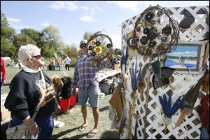 Judy Palinski of Temperance talks with vendor Andy Baxter of Lakewood, Ohio.