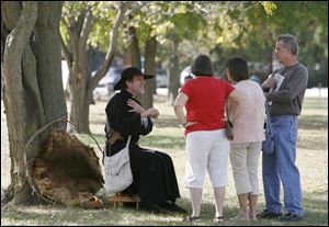 Slug: CTY CAMP10p Date: 10092010  The Blade/Andy Morrison   Location: Bowling Green Caption: Dressed as a Jesuit missionary, Craig McGirr, left, Bridgman, Michigan, speaks to Harriet Treaaway, left, Toledo, and June and Don Goetz, Helena, at the Revolutionary War encampment at the Wood County Historical Center & Museum, Saturday, 10092010.