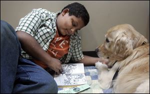 Daniel Swain-Brown, 9, reads to Precious.