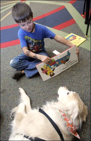 Kyle Roessle, 6, of Temperance reads to Finnie. 