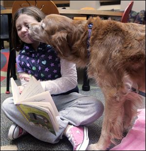 Porsche gives kisses to Isabella Becker, 8, of Temperance.
