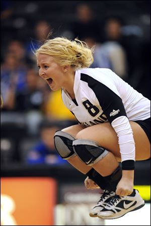 Brittany Dunn jumps for joy as a member of Oakland University's volleyball team. The Bowling Green High School graduate is the team's lone senior.