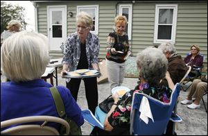 Lisa Exner, left, and Sherry Seiler, owners of the Silver Lining Gallery in Waterville, distribute refreshments to those who attended a workshop at their store.