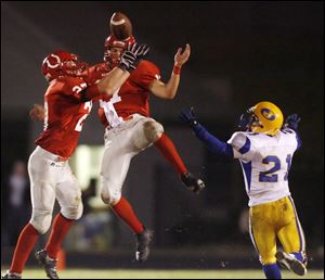 Bedford's Erik Jones intercepts a pass intended for Monroe Jefferson's Eric Morrow with the Mules' Jared Kujawa also defending on the play.