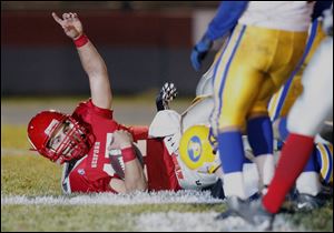 Bedford quarterback Jared Kujawa reaches the end zone for one of his seven touchdowns against Monroe Jefferson.