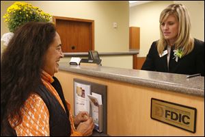 BIZ bank25p  Therese (cq) King, of Toledo, left, in the new branch with Sarah Florian, right. A new branch downtown for Fifth Third, replacing one they closed a block away a year ago, in Toledo, Ohio on October 25, 2010. Jetta Fraser/The Blade