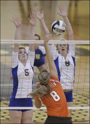 Katie McKernan (5) and Maggie Burnham (8) put up a wall against Southview's Kelsey Blankerts in last night's second match. 