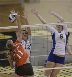 St. Ursula's Madison Strall (12) blocks a hit by Southview's Julia Mouch while the Arrows' Cassidy Croci looks to assist.