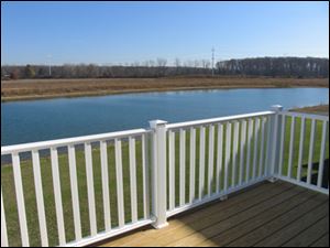 The balcony offers a peaceful view that includes a forest and the lake. A bike trail is nearby.