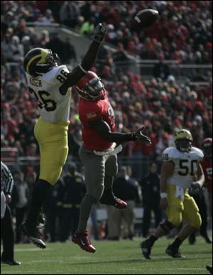 A pass intended for Kevin Koger is broken up by Ohio State's Brian Rolle.
