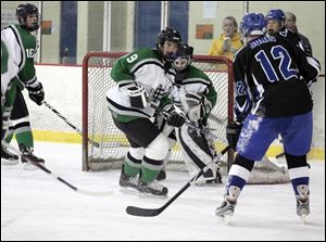 Springfield's Sean Jones goes toward the net against Ottawa Hills' Thomas Knopp and goaltender Alli Frederick. The Blue Devils won the NHC Blue Division last year.