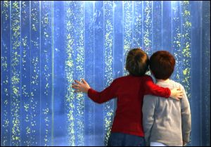  Carson Daill, 7, left, of Monroe and Jackson Heflin, 6, also of Monroe look at a wall of water and bubbles at the Imagination Station in downtown Toledo during a week of wintry fun at the center.