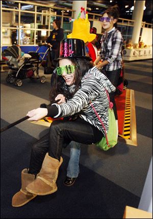  Jocelyn Tingley, 13, of Toledo, pulls with all her might on the rope at the 'Giant Lever' at the Imagination Station. In addition to the wintertime activities, a yo-yo demonstration is on hand for Thursday.