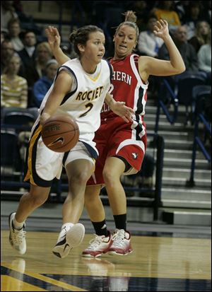 Toledo's Courtney Ingersoll dribbles around Northern Illinois' Brittney Callahan during last night's game at Savage Arena.