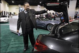 SLUG: CTY toledoauto26p           1/26/2011 The Blade/Amy E. Voigt                     Toledo, Ohio  CAPTION:  Ray Wood, left, president of UAW Local 14, checks out the  2011 Chevrolet Cruze 1LT during the Auto Show gala on January 26, 2011.