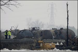 The wrecked tank cars are being removed as they burn out so the track can be repaired. 