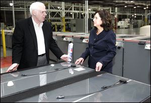 U.S. Secretary of Labor Hilda Solis speaks with Michael Cicak, CEO of Willard & Kelsey Solar Group, at the firm's plant in Perrysburg. She called the company key in helping replace lost manufacturing jobs. 