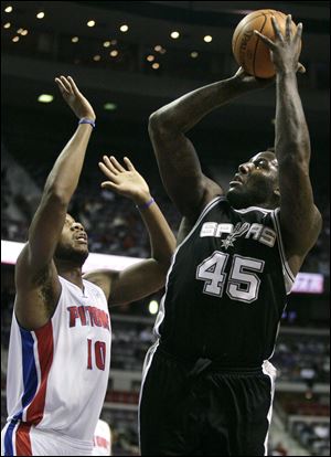 San Antonio's DeJuan Blair shoots over Detroit's Greg Monroe. Blair finished with 18 points and 12 rebounds in Tuesday's game.