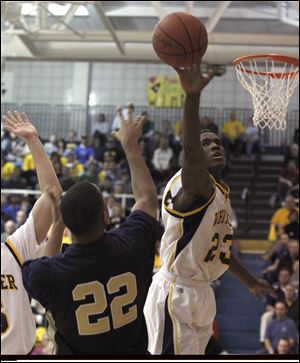 Whitmer's Nigel Hayes blocks a shot by Jeff Copeland of St. John's during second-half action.