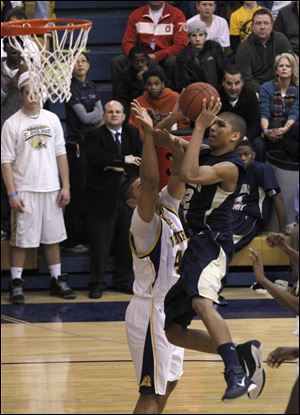  Whitmer's Chris Wormley fouls St. John's Marc Loving in the fourth quarter. Wormley fouled out on the play. Loving scored 10 of his 12 points in the second half. 