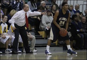 Whitmer coach Bruce Smith yells for his team to guard Cheatham Norrils of St. John's. Norrils led the Titans with 14 points, six of which came in the fourth quarter, as St. John's took control of the contest.