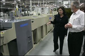 Hilda Solis, U.S. secretary of labor, gets a tour of the Perrysburg factory from plant manager Vince Poleo. 