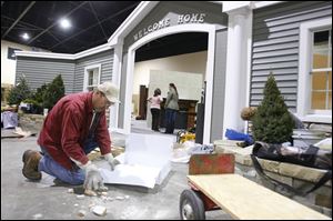 Kirk Wylie cleans up after doing some work helping set up for the House and Home Show.